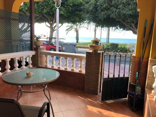 a patio with a table and a view of the ocean at Apartamentos casa Tia Antonia in Málaga