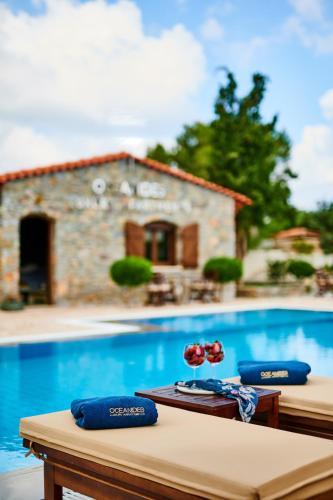 a table with flowers on it next to a swimming pool at Nectar luxury apartments in Sitia