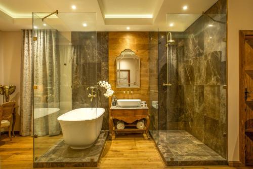 a bathroom with a bath tub and a sink at The Giglio Boutique Hotel in Johannesburg