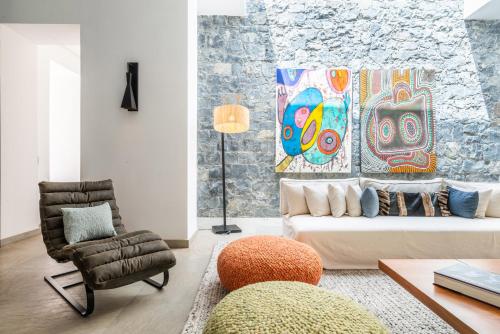 a living room with a couch and a chair at Zagora and Marhba villas Marrakech - by EMERALD STAY in Marrakech