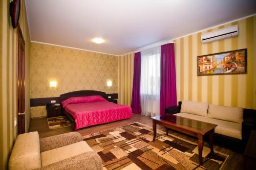 a living room with a bed and a couch at City Club in Kharkiv