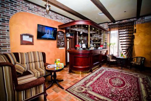 a bar with a couch and a chair in a room at City Club in Kharkiv
