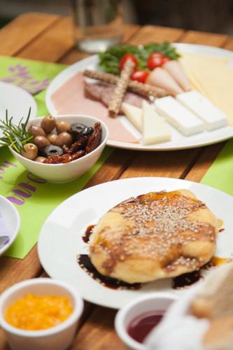 a wooden table with plates of food on it at Gioma Hotel in Agia Galini