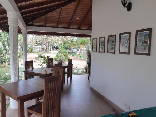 a dining room with wooden tables and chairs at Tamarind Tamarind Resort, Tourist Board Approved in Habarana