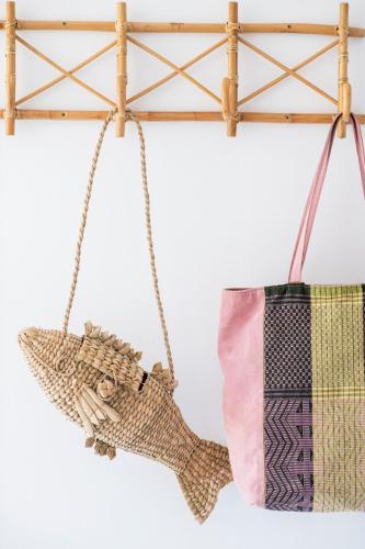 a hammock swing with a bag on a wall at Curolla Petit Hotel in Maria de la Salut