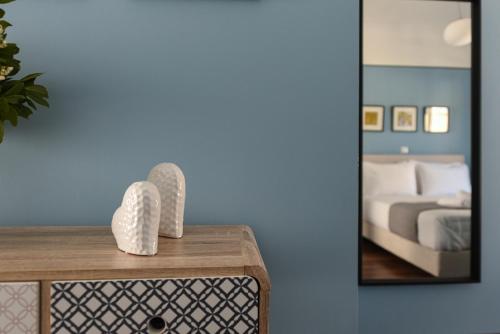 a bedroom with a mirror and a dresser with a bed at ATHENS STORIES in Athens