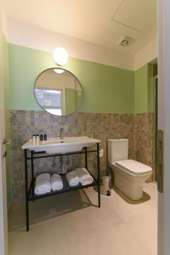 a bathroom with a sink and a toilet and a mirror at ATHENS STORIES in Athens
