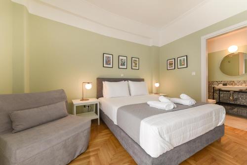 a hotel room with a bed and a couch at ATHENS STORIES in Athens