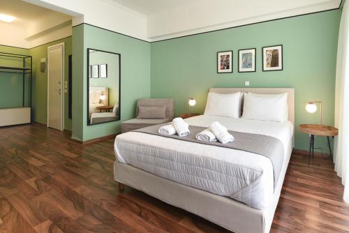 a bedroom with a large bed with two towels on it at ATHENS STORIES in Athens