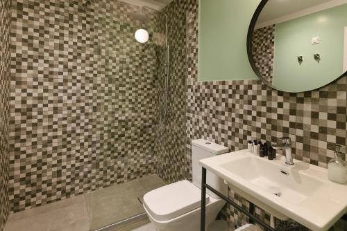 a bathroom with a toilet and a sink and a mirror at ATHENS STORIES in Athens