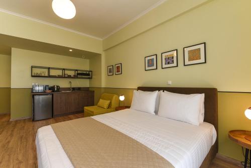 a bedroom with a bed and a table and a chair at ATHENS STORIES in Athens
