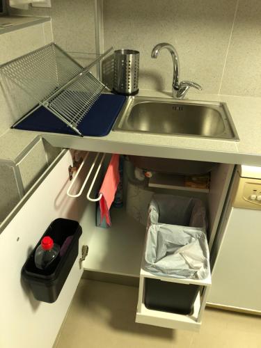a kitchen counter with a sink and a trash can at BADAROSA House10min to BARCELONA City&NearTo BEACH in Badalona