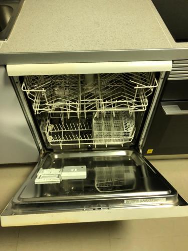 an open dishwasher with a rack of dishes in it at BADAROSA House10min to BARCELONA City&NearTo BEACH in Badalona