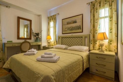 a bedroom with two beds with towels on them at Elaia Villas in Pythagoreio