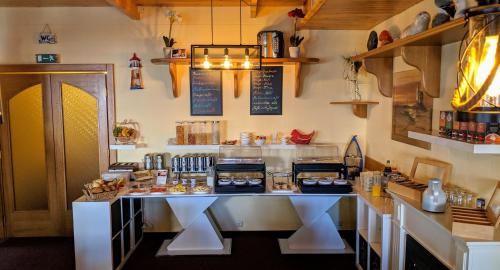 a kitchen with a counter with food on it at Hotel Drostenhof garni in Esens