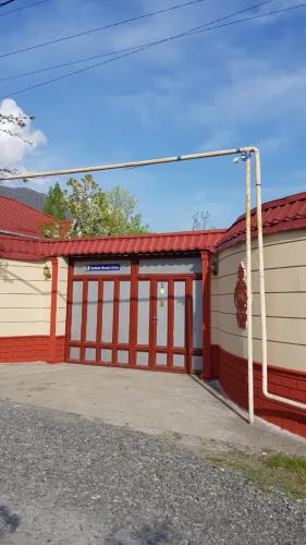 a red and white building with a garage at Gabala Homes Musa in Gabala
