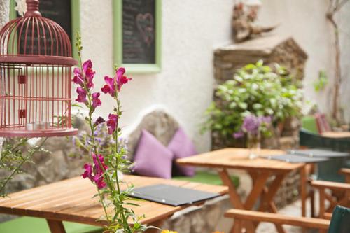 a bird cage sitting on top of a wooden table at Gioma Hotel in Agia Galini