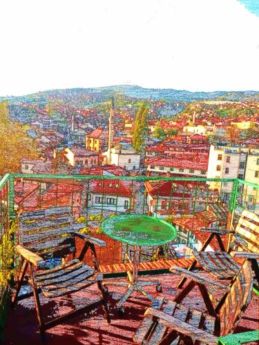 a view of a table and chairs and a city at Apartments Emily in Sarajevo