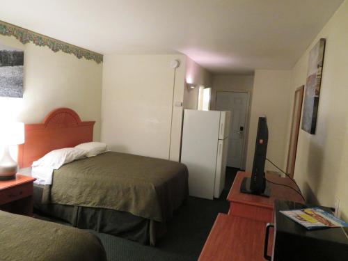 a hotel room with two beds and a refrigerator at Carquinez Inn in Vallejo