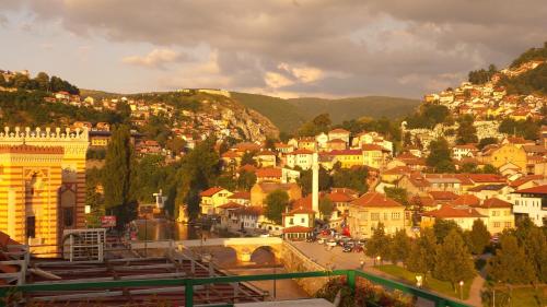 a view of a town with a bridge and buildings at Apartments Emily in Sarajevo