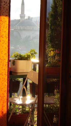 a view of a window with a table with plants at Apartments Emily in Sarajevo