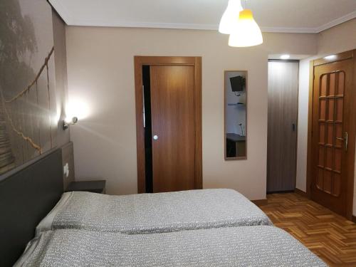 a bedroom with a bed in a room at Pension Santiago in Burgos