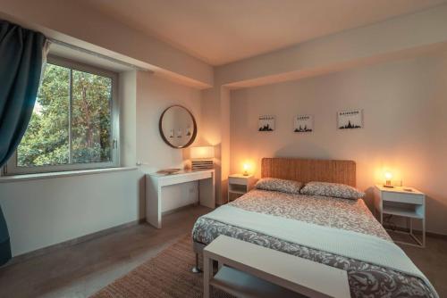 a bedroom with a bed and a window at The charming house in Taormina