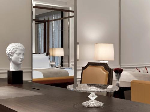 a living room with a table and a bedroom at Baccarat Hotel and Residences New York in New York