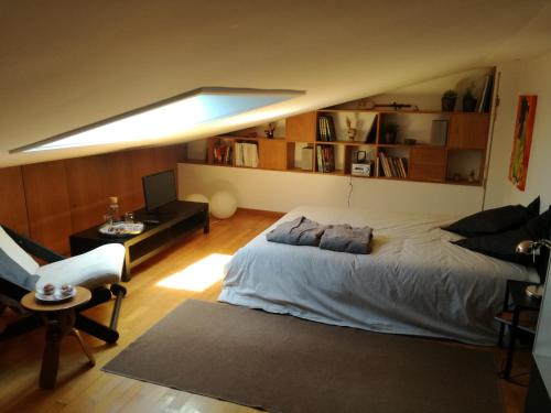 a bedroom with a large bed and a couch at Leça Room in Leça da Palmeira