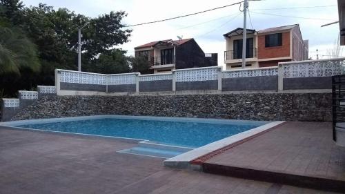 a swimming pool in front of a house at Villas de Santa Ana in Guamo