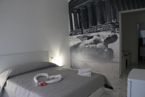 a bedroom with a bed with two swans on it at Amantea Monument in Terrasini