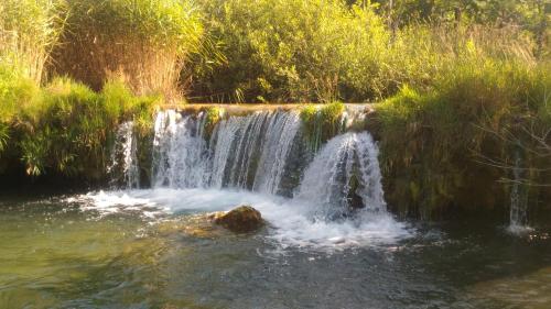 a waterfall in the middle of a pool of water at Kuća za odmor Zeleni biser in Generalski Stol