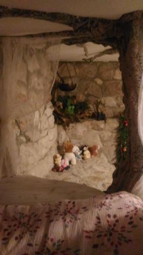 a group of stuffed teddy bears in a fireplace at Kuća za odmor Zeleni biser in Generalski Stol