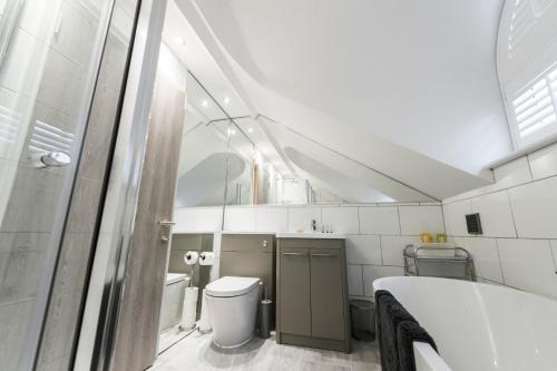 a bathroom with a sink and a toilet and a tub at Nadler House Flat 1 & 2 in Norwich