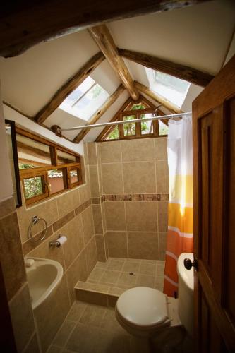 a bathroom with a toilet and a sink at Casa De Aida in Calca
