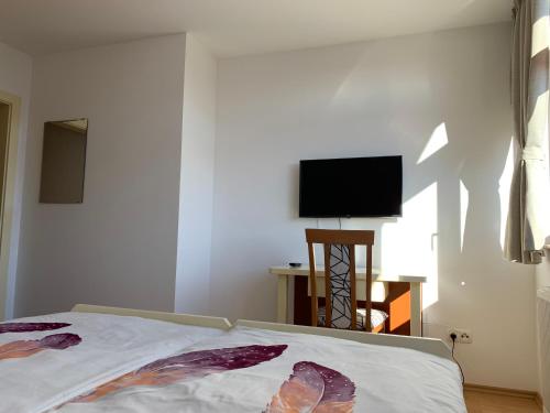 a bedroom with a bed and a flat screen tv at Vinarija Zlatar in Zlatar