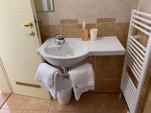a white sink in a bathroom with towels at Vinarija Zlatar in Zlatar
