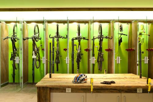 a room with a bunch of umbrellas on a wall at Explorer Hotel Oberstdorf in Fischen