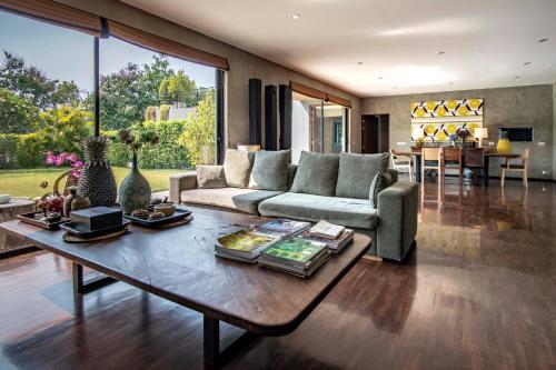 a living room with a couch and a table at Natural Villas Chiang Mai Luxury Private Pool in Chiang Mai