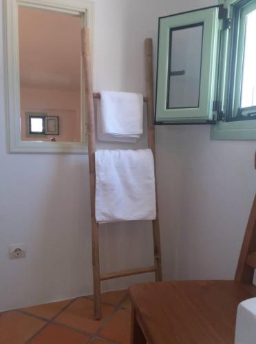 a towel rack in a bathroom with a mirror at Absolute Matala in Matala