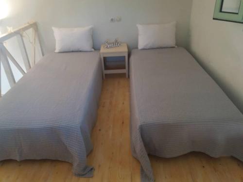 two beds sitting next to each other in a room at Absolute Matala in Matala