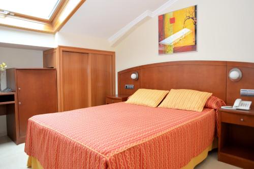 Postel nebo postele na pokoji v ubytování Hotel Portonovo