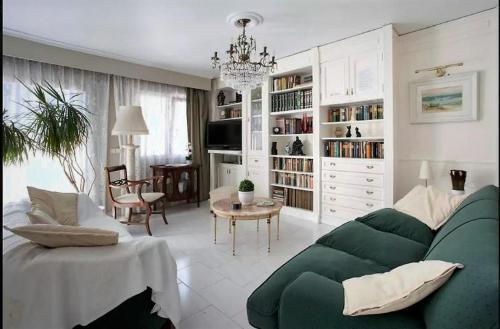 a living room with a green couch and a table at ADOSADO DE LUJO CON PISCINA PRIVADA en ZONA MUY TRANQUILA in Gandía