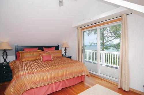 a bedroom with a bed and a large window at Cozy Lake Michigan Cottage on Lake Michigan-Pet Friendly! in Sheboygan