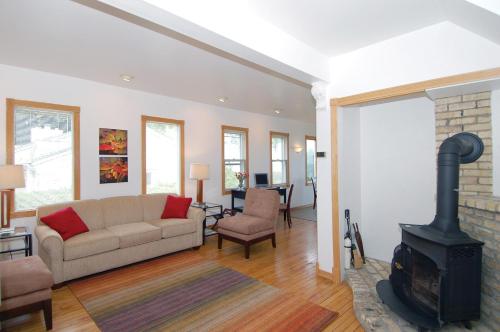 a living room with a couch and a fireplace at Cozy Lake Michigan Cottage on Lake Michigan-Pet Friendly! in Sheboygan