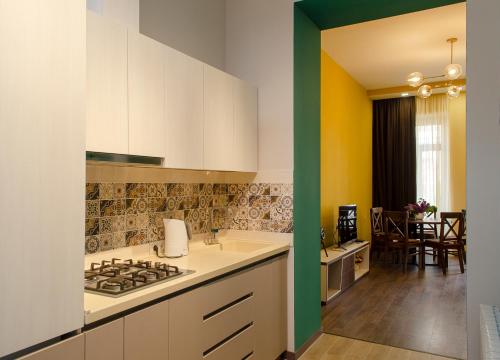 a kitchen with a sink and a stove at Home@97 on Aghmashenebeli Avenue in Tbilisi City