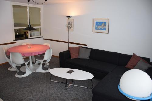 a living room with a couch and a table at Apartment Center Zermatt in Zermatt