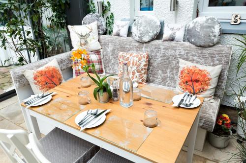 a table and chairs on a patio with a table and sidx sidx at JustB Edinburgh in Edinburgh