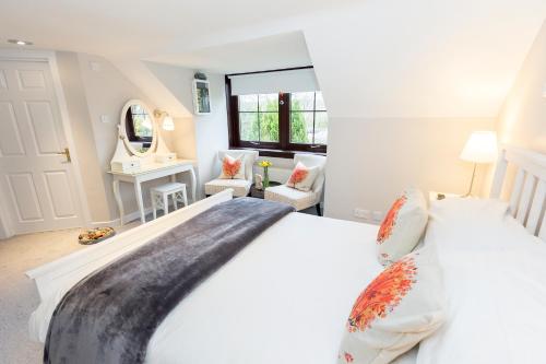 a bedroom with a large white bed and a mirror at JustB Edinburgh in Edinburgh