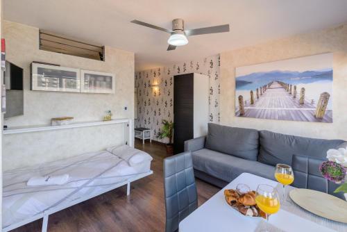 a living room with a couch and a table at Apartamento costa del oro in Torrox Costa